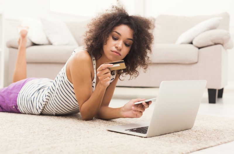 Woman shopping online with credit card